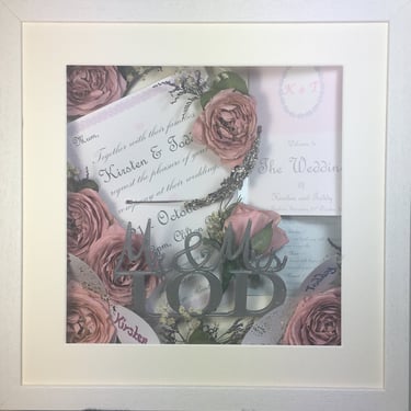 memory box full of wedding items, cake topper and preserved wedding bouquet flowers in a deep frame