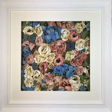 a pink and blue flower wall style preserved wedding bouquet in a frame