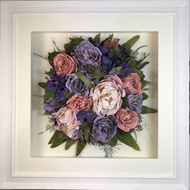 a photo of a Birdseye view preserved wedding bouquet in a frame