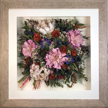 a photo of a Birdseye view preserved wedding bouquet in a frame