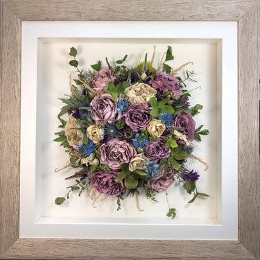Birdseye view preserved wedding bouquet of purple and blue in a frame