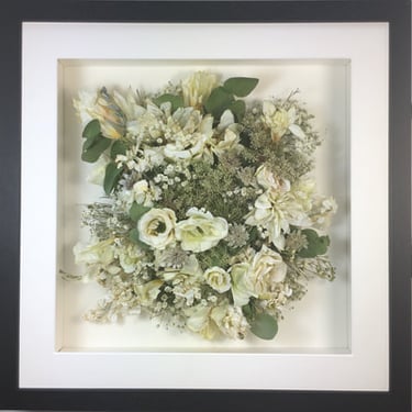 a photo of a Birdseye view preserved wedding bouquet in a frame