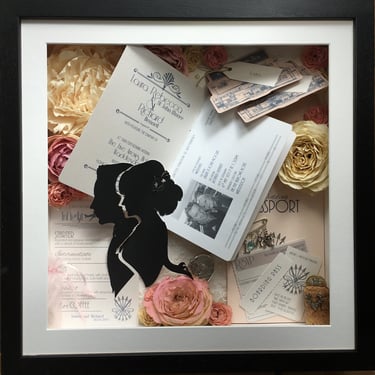 memory box full of preserved wedding flowers and passport themed invitation