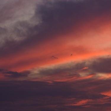 Dramatic burnt orange Texas sunset with vivid, fiery clouds filling the sky