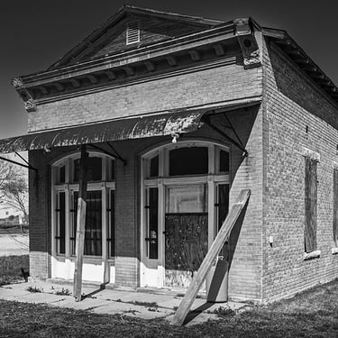 Empty and derelict small brick building in downtowon Weir, TX circa 2013. Perhaps a bank or post office in its day.