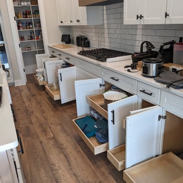 A kitchen full of custom slide out shelves.