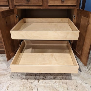 Two large base cabinet pull outs displaying the amount of added storage they provide.