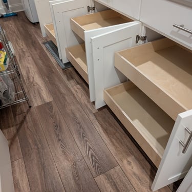 Pull-out drawers added to base cabinets in a laundry room.