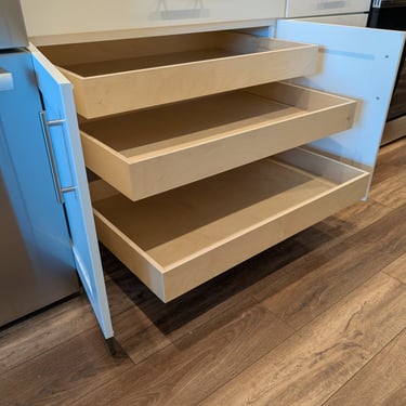 Triple  roll-out shelves in a base cabinet significantly increase storage space.
