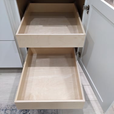 Two custom slide out shelves extended from a white kitchen cabinet.