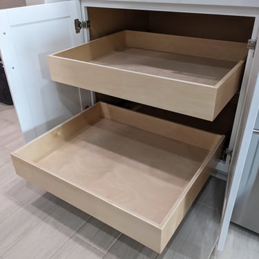 A white cabinet with Double kitchen cabinet pull outs installed.
