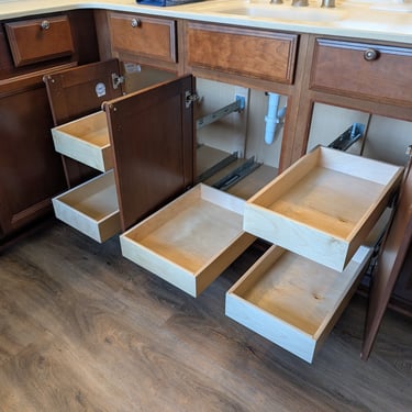 A large bathroom vanity has five pull out cabinet drawers added to the lower half of the cabinet.