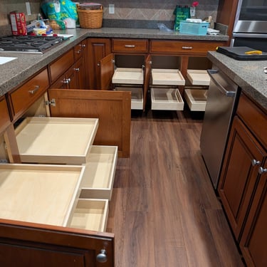 A kitchen with ten slide-out drawers extended, showing the easy access they provide for lower cabinets.