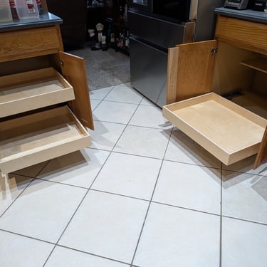 Custom glide-out shelves installed in two different cabinets.