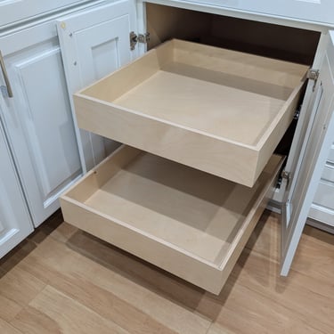 Two cabinet drawers increase available storage relative to the previous small shelf.