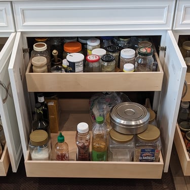 Pull out shelving in a kitchen cabinet for maximum convenience.