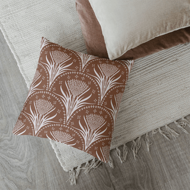 a pillow with a brown and beige seamless nature pattern design Bali inspiration