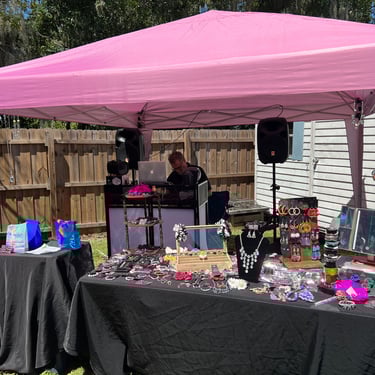 dj and prop table under tent