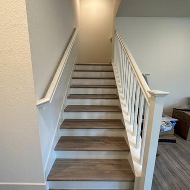 full stairs treads installed with white stair raisers on stairs renovation.