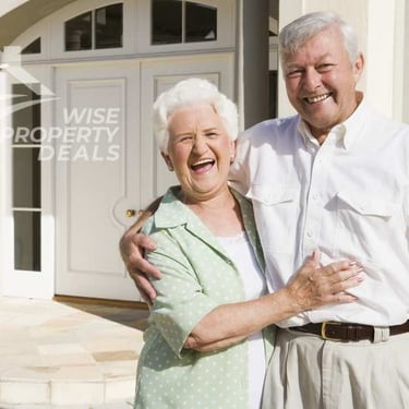 a man and woman standing in front of a house
