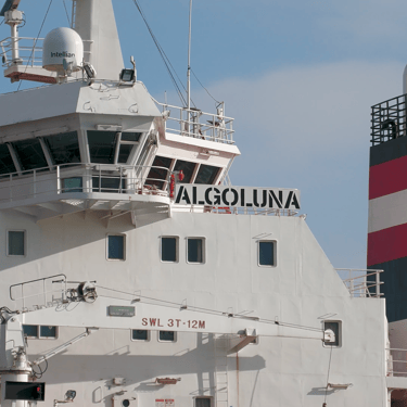 Close-up view of the port side of the pilot house and funnel of tanker ship Algoluna.