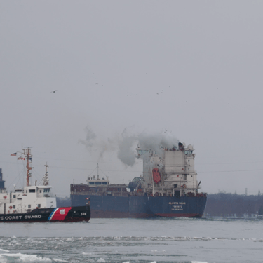 U.S. Coast Guard Cutter Morro Bay passing behind the sterns of Algoma Bear and Algoluna, after completing an ice escort.