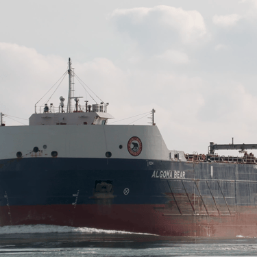 Close-up view of the port side bow of freighter Algoma Bear, as it displaces water at river speed.