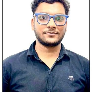 a man with glasses and a blue shirt