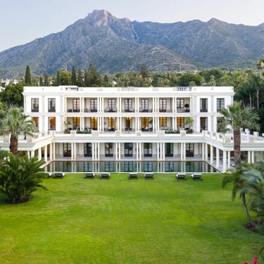 Villa exterior with landscaped lawns and mountain views