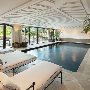 Indoor heated pool with loungers and garden access