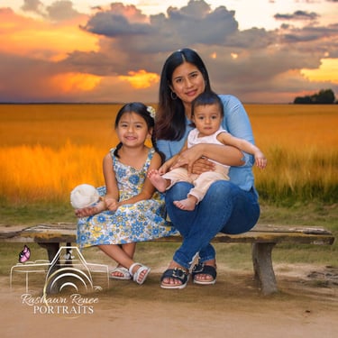 a woman sitting on a bench with two young children