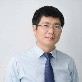 a man in a blue shirt and tie tie