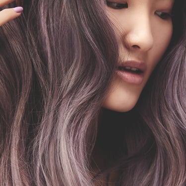 a woman with long hair and purple hair
