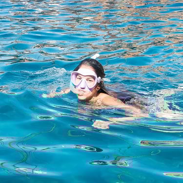 chica en el mar con mascara de snorkel 