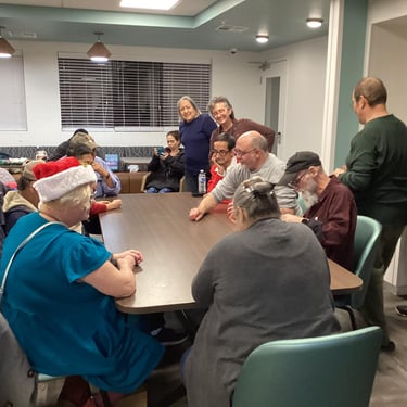 Group of people sitting around rectangle table 