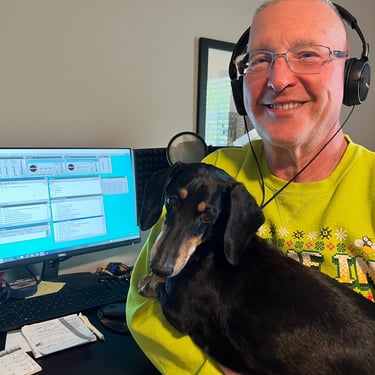 a man in a green shirt is holding a dog