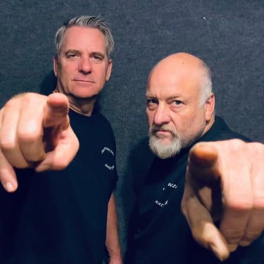 two men pointing their fingers at the camera