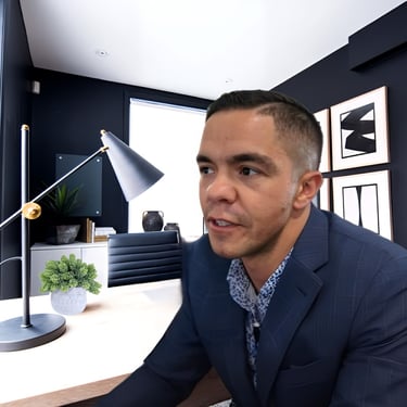 Cody Sechelski sitting in a suit, reflecting on his transformation after incarceration 15 years ago