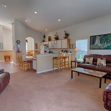 a living room with a couch and a table in open plan villa in Florida
