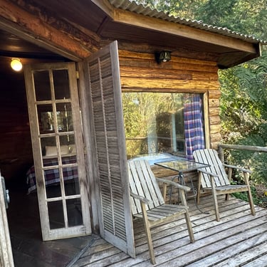 a wooden deck with a table and chairs