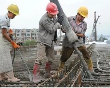 A team workers pouring concrete soil to the floor slab on a construction site