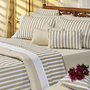 a bed with a bouquet of flowers on it