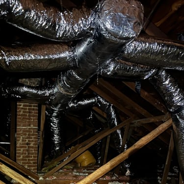 Ductwork running through an attic to the HVAC system in order to carry air throughout the home.