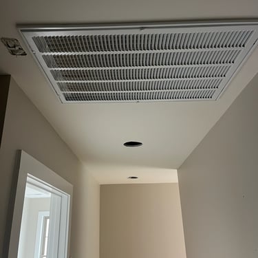 Ceiling grill from a HVAC installation to provide heating and cooling