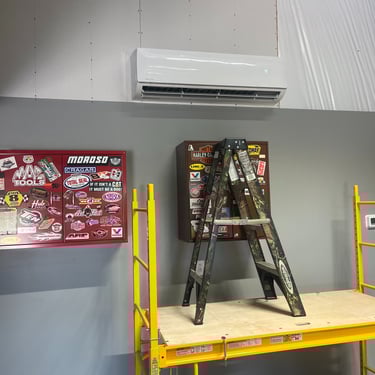 Mini split installed in a garage to bring heating and cooling to a new space.