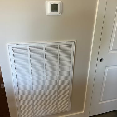 Thermostat and return grill on the wall after complete HVAC installation in Mount Juliet, TN home