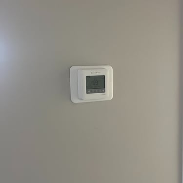 Thermostat being show as final walk through of HVAC installation in Lebanon, TN
