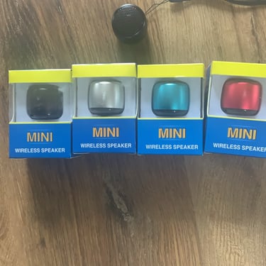 a group of three mini speakers with a microphone