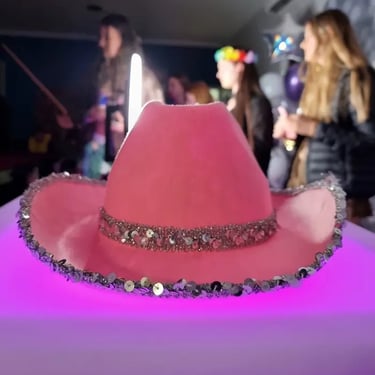 Pink cowboy hat on the glowing cocktail table at a photo booth session in Redland Bay.