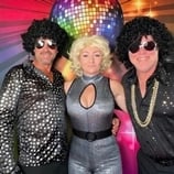 Party goers in disco costume posing in the open air photo booth at event in Capalaba.
